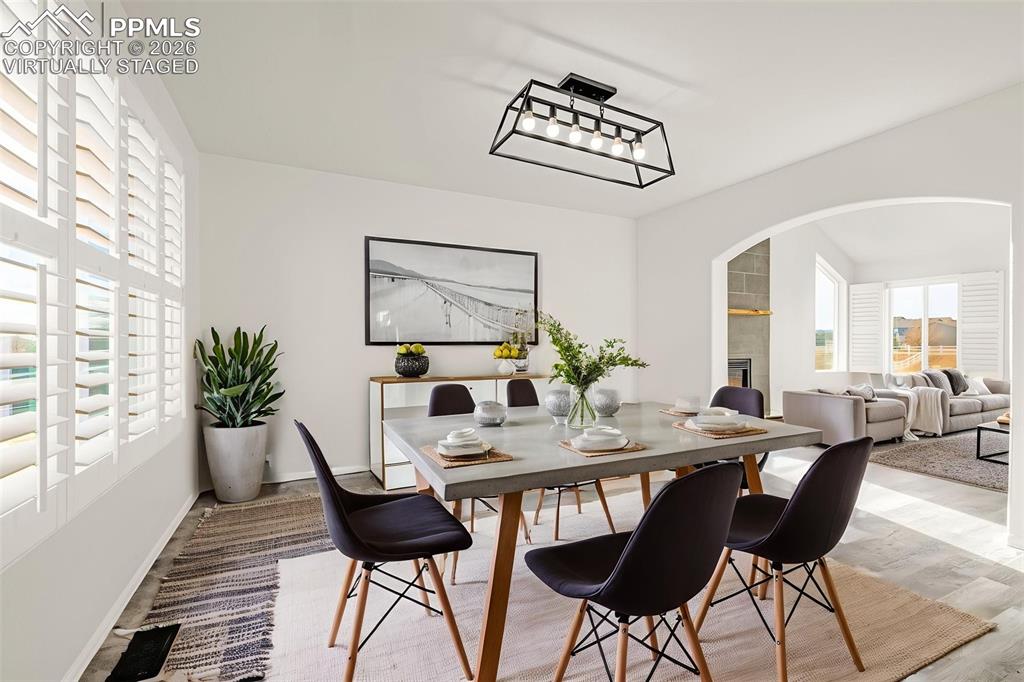 8388 Fort Smith Road Peyton, CO 80831 - Photo 23 of 49 a view of a dining room with furniture and wooden floor
