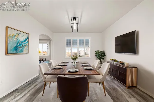 a view of a dining room with furniture window and wooden floor