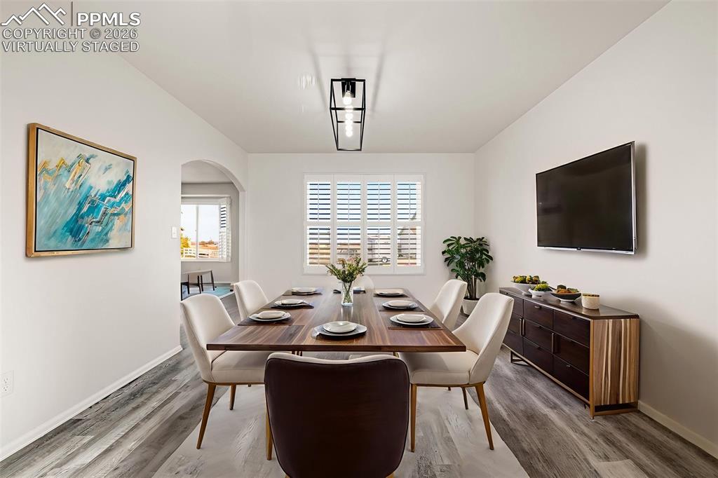 8388 Fort Smith Road Peyton, CO 80831 - Photo 24 of 49 a view of a dining room with furniture window and wooden floor