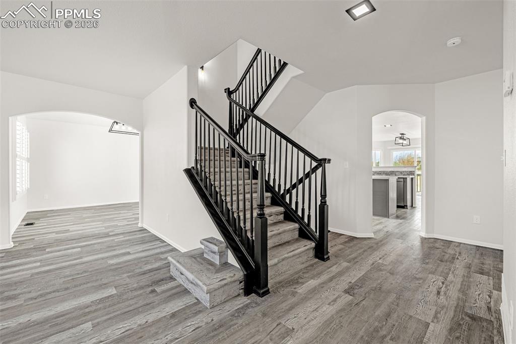 8388 Fort Smith Road Peyton, CO 80831 - Photo 28 of 49 a view of a hallway with wooden floor and stairs