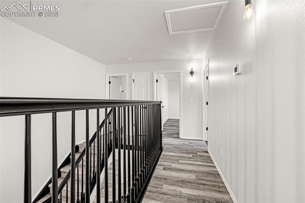 8388 Fort Smith Road Peyton, CO 80831 - Photo 29 of 49 a view of a hallway with wooden floor and staircase