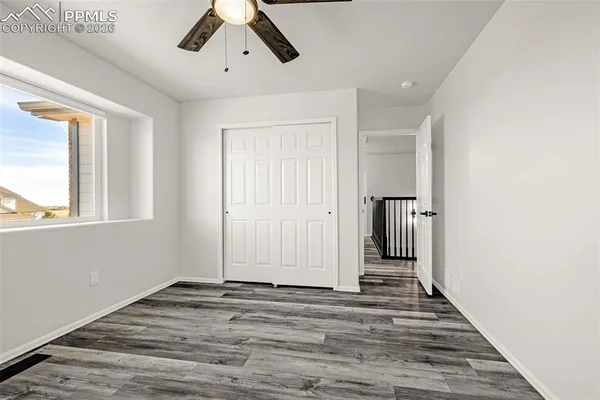 a view of a livingroom with wooden floor and window