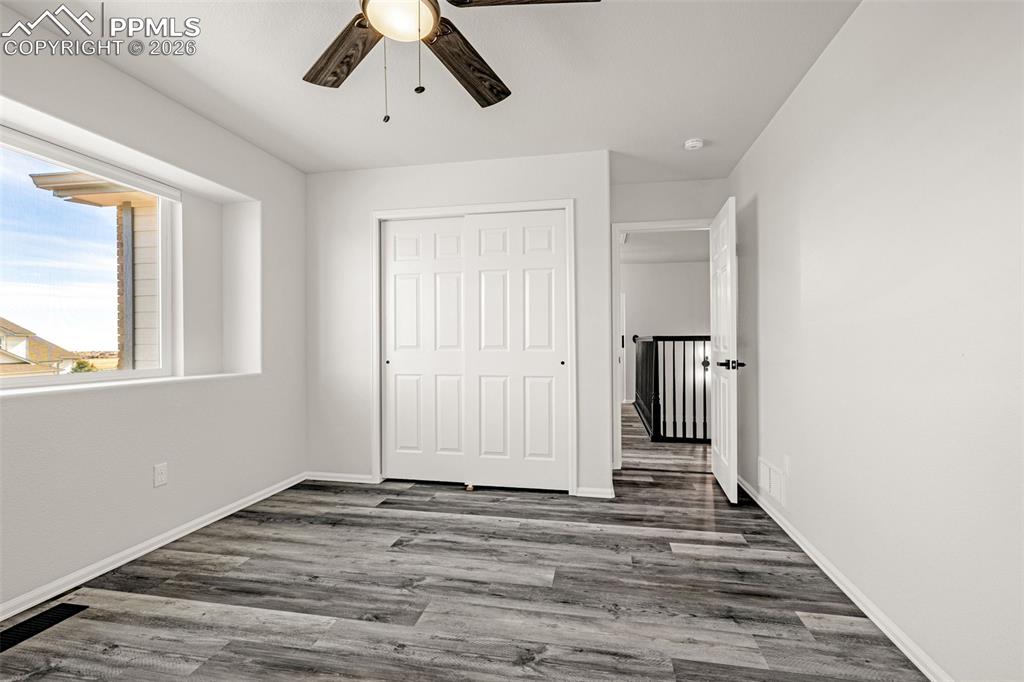 8388 Fort Smith Road Peyton, CO 80831 - Photo 33 of 49 a view of a livingroom with wooden floor and window