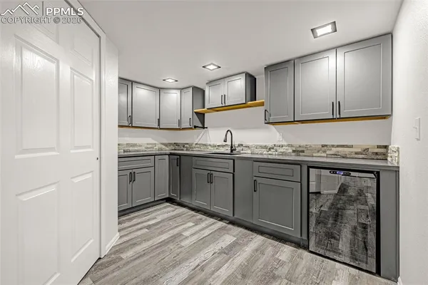a kitchen with a refrigerator sink and cabinets