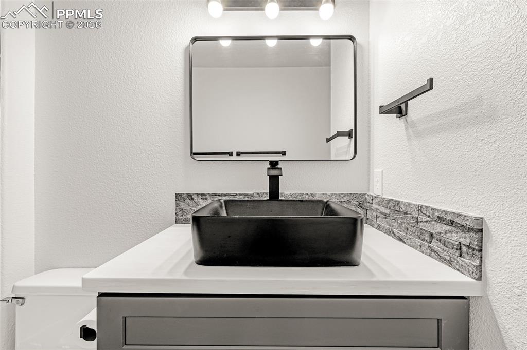 8388 Fort Smith Road Peyton, CO 80831 - Photo 40 of 49 a bathroom with a sink and a mirror