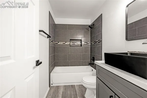a bathroom with a toilet a sink and bathtub