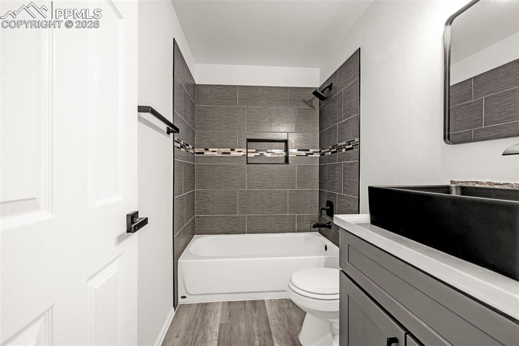 8388 Fort Smith Road Peyton, CO 80831 - Photo 42 of 49 a bathroom with a toilet a sink and bathtub