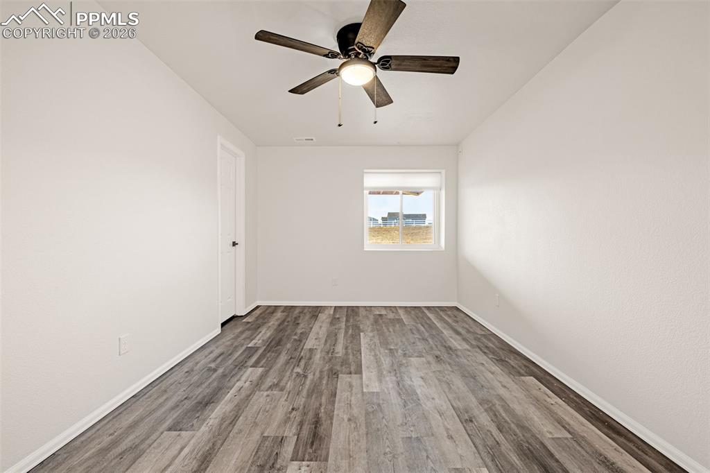 8388 Fort Smith Road Peyton, CO 80831 - Photo 43 of 49 an empty room with a window and a ceiling fan