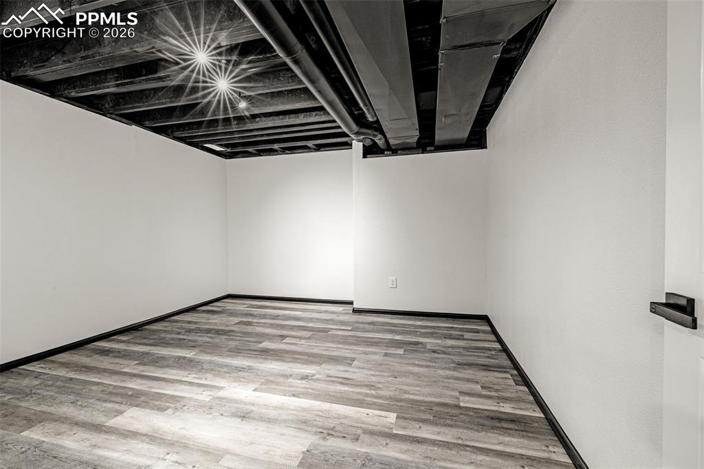 8388 Fort Smith Road Peyton, CO 80831 - Photo 45 of 49 a view of an empty room with wooden floor