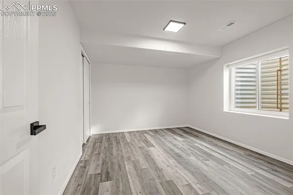 wooden floor in an empty room with a window