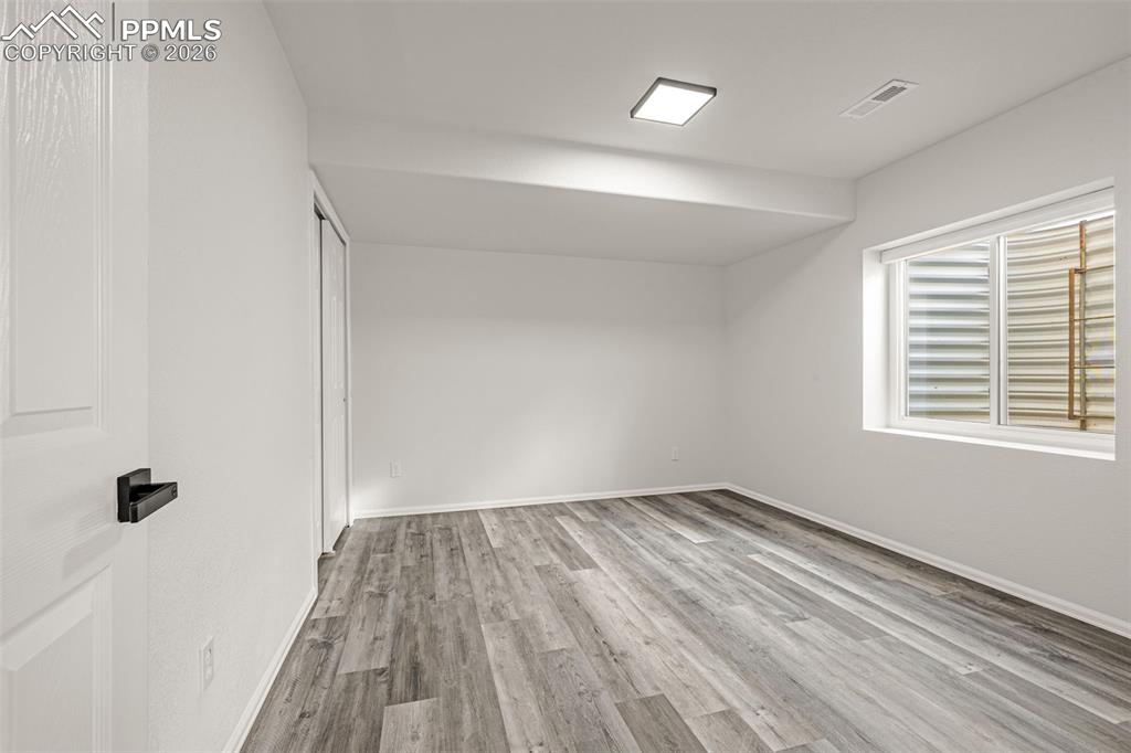 8388 Fort Smith Road Peyton, CO 80831 - Photo 46 of 49 wooden floor in an empty room with a window