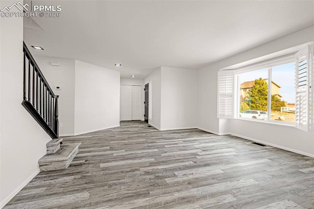8388 Fort Smith Road Peyton, CO 80831 - Photo 5 of 49 wooden floor in an empty room with a window