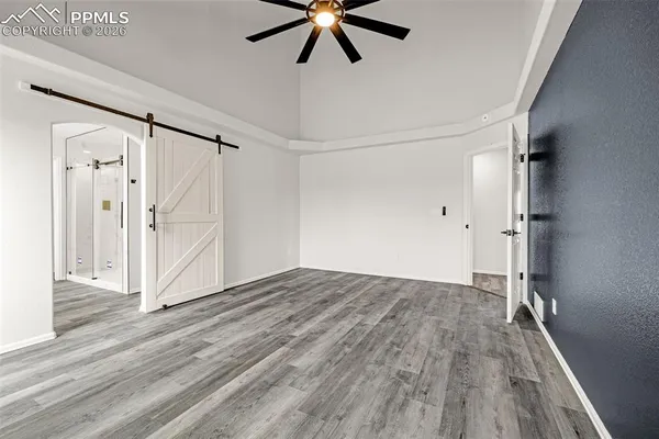 a view of empty room with wooden floor