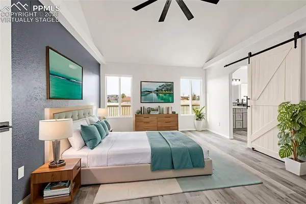 a bedroom with a large bed and a flat screen tv