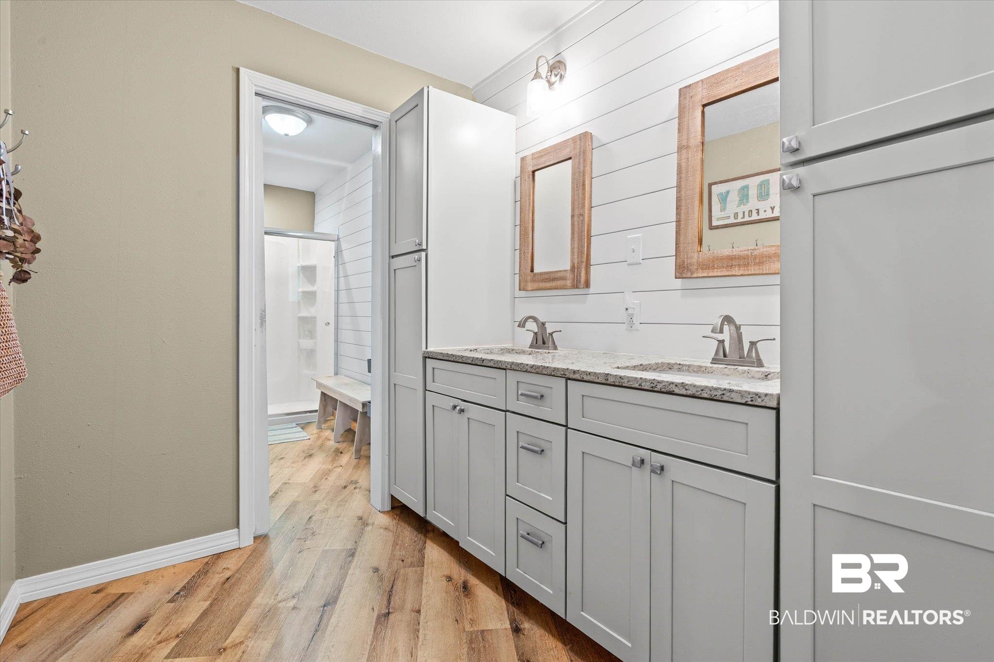 9100 Shell Belt Road Coden, AL 36523 - Photo 16 of 38 Double vanity with light gray cabinetry, stone-finish countertops, and dual framed mirrors