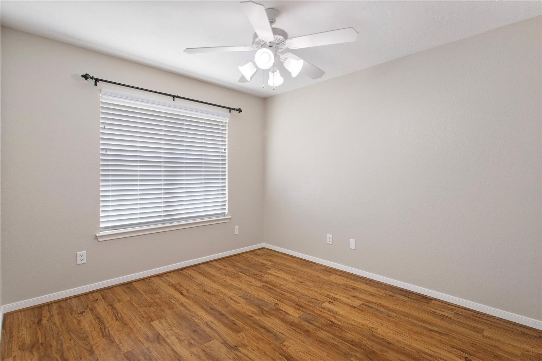 2023 Mountain Wind Loop Bryan, TX 77807 - Photo 13 of 16 wooden floor in an empty room with a window