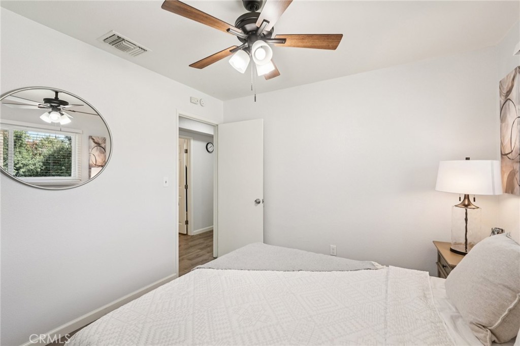 975 Brookside Avenue Redlands, CA 92373 - Photo 11 of 20 a bedroom with a bed and a chandelier