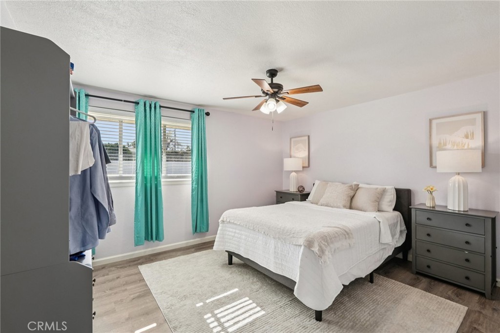975 Brookside Avenue Redlands, CA 92373 - Photo 13 of 20 a bedroom with a large bed and a chandelier