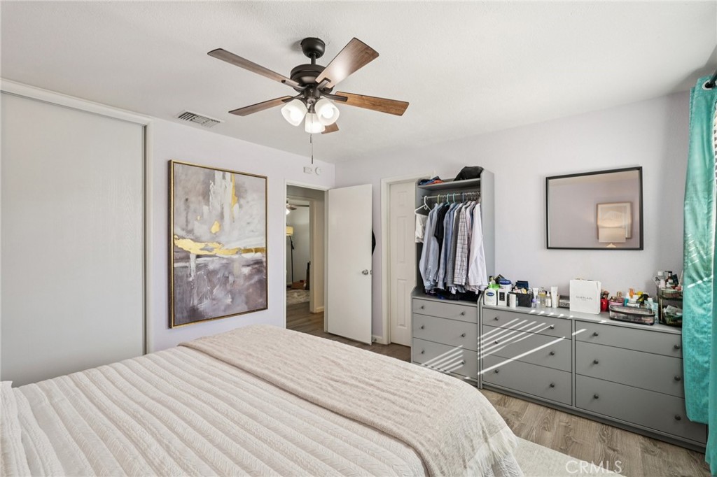 975 Brookside Avenue Redlands, CA 92373 - Photo 14 of 20 a bedroom with a bed and a chandelier
