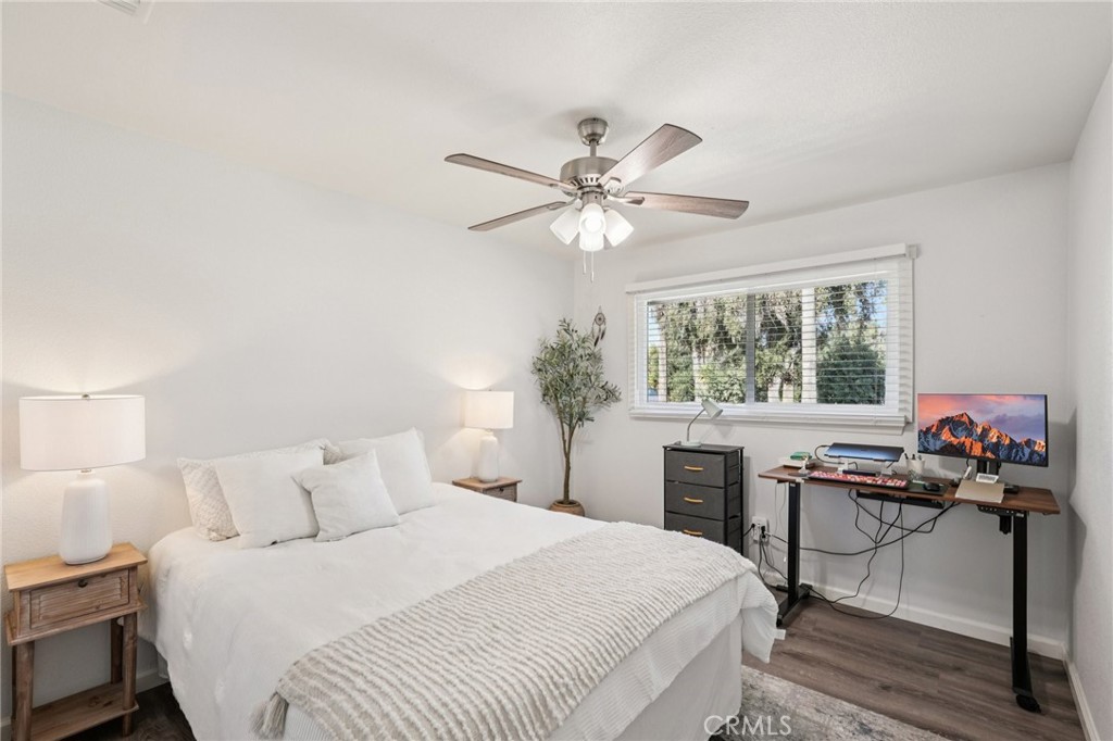 975 Brookside Avenue Redlands, CA 92373 - Photo 17 of 20 a bedroom with a large bed and a chandelier