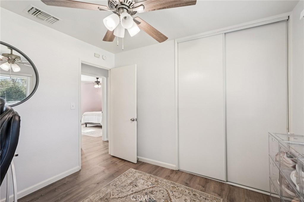 975 Brookside Avenue Redlands, CA 92373 - Photo 9 of 20 a view of a hallway with wooden floor and a chandelier fan