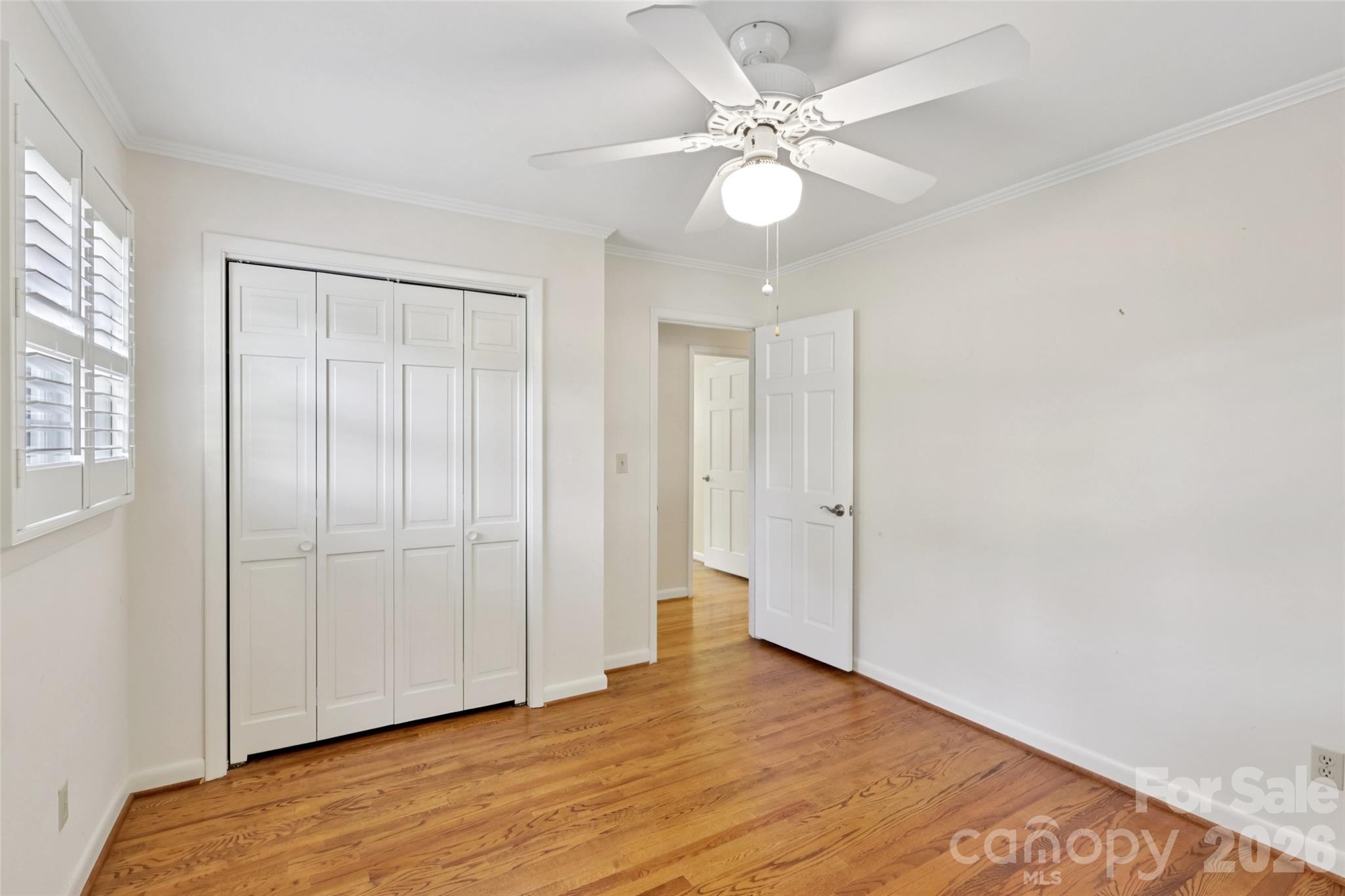 1002 Ridge Street Albemarle, NC 28001 - Photo 28 of 45 an empty room with wooden floor and ceiling fan