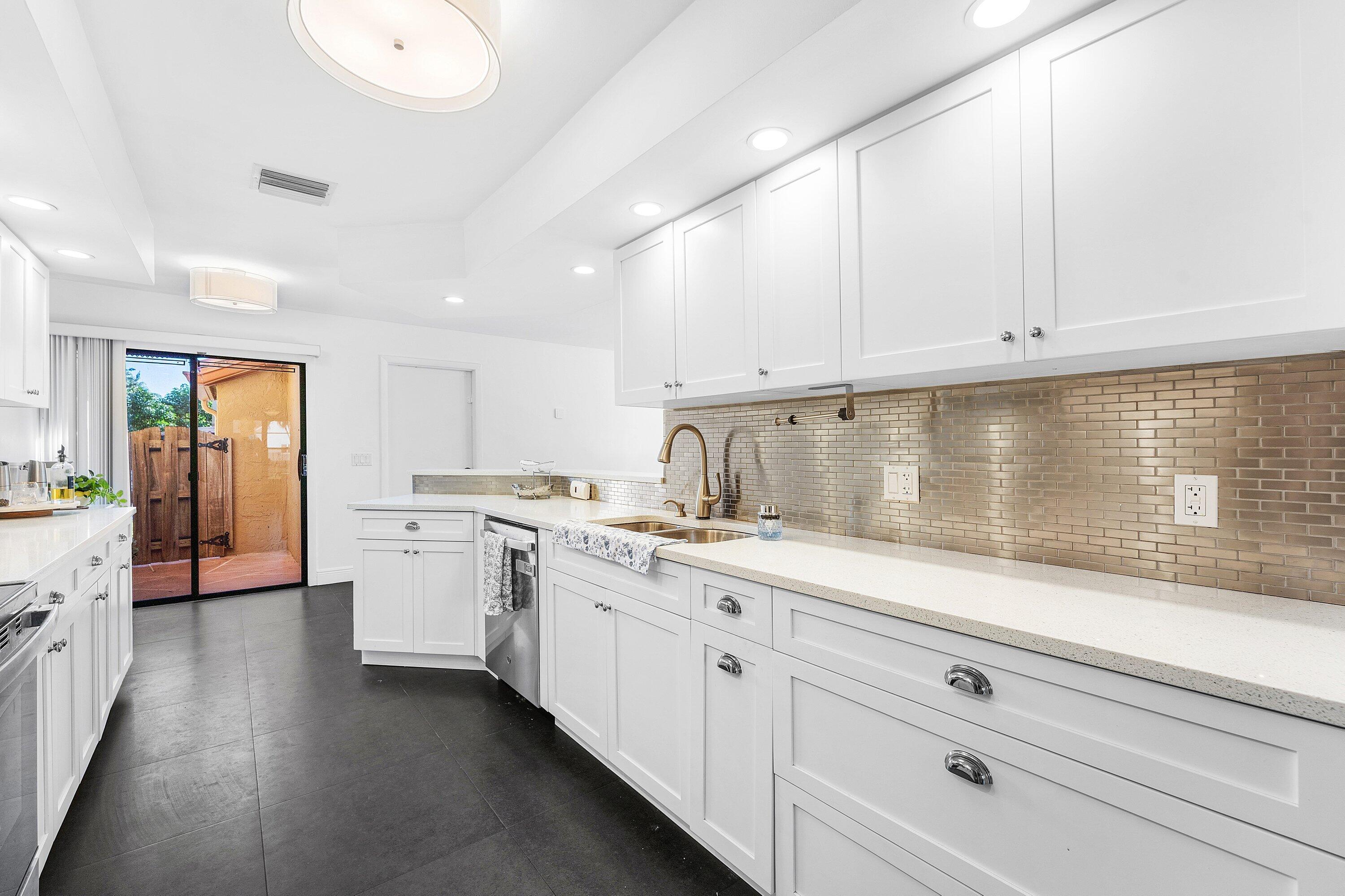 19931 Villa Lante Place Boca Raton, FL 33434 - Photo 11 of 49 a kitchen with sink cabinets and window
