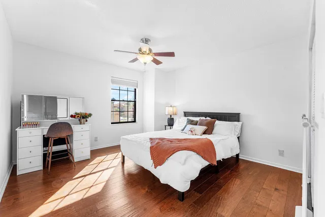 a bedroom with a bed and wooden floor