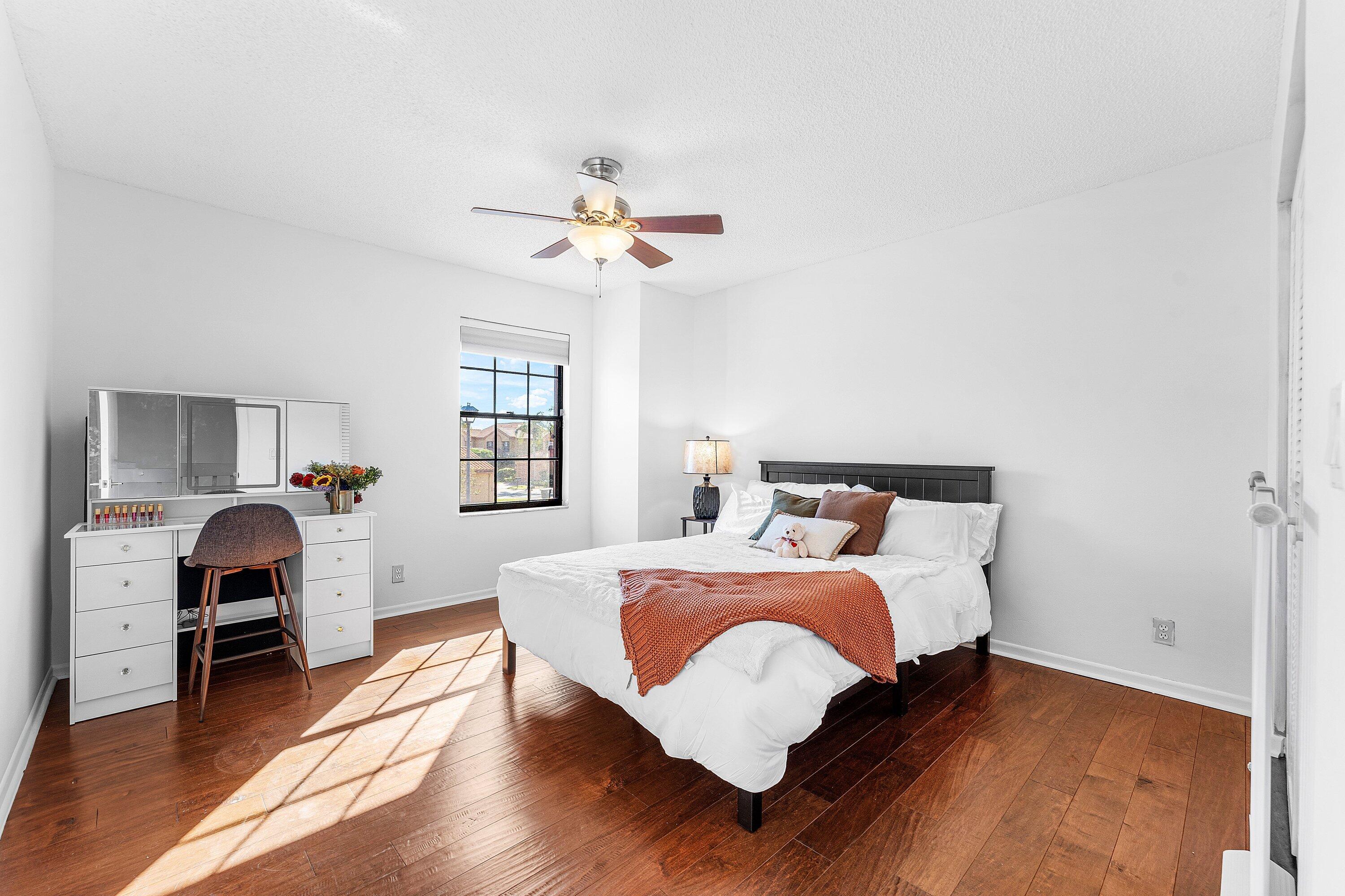 19931 Villa Lante Place Boca Raton, FL 33434 - Photo 19 of 49 a bedroom with a bed and wooden floor
