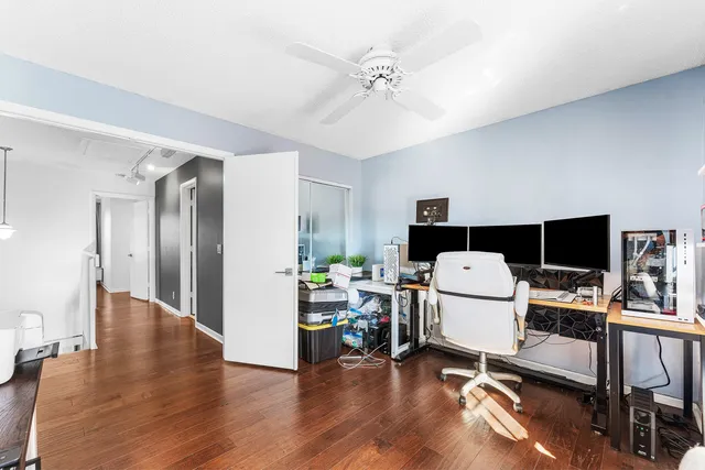 a view of a workspace with furniture and a flat screen tv