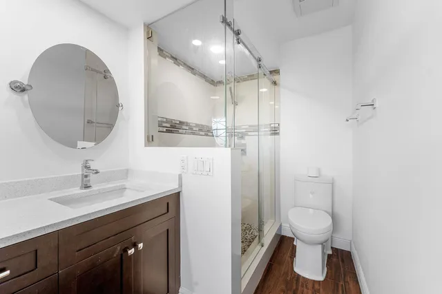 a bathroom with a sink toilet and shower