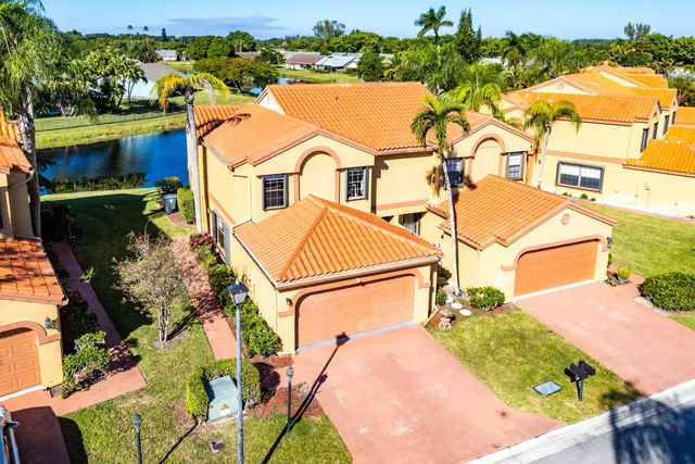an aerial view of a house with a yard and pool