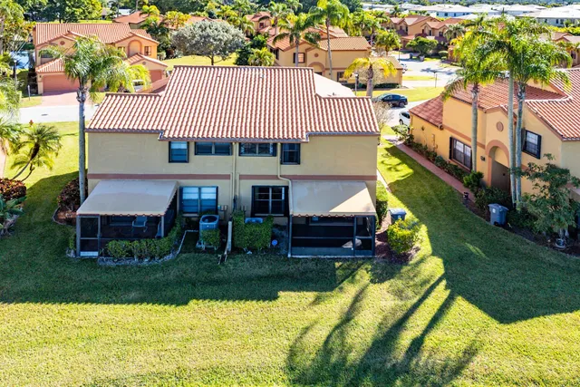 a view of house with garden space and sitting area