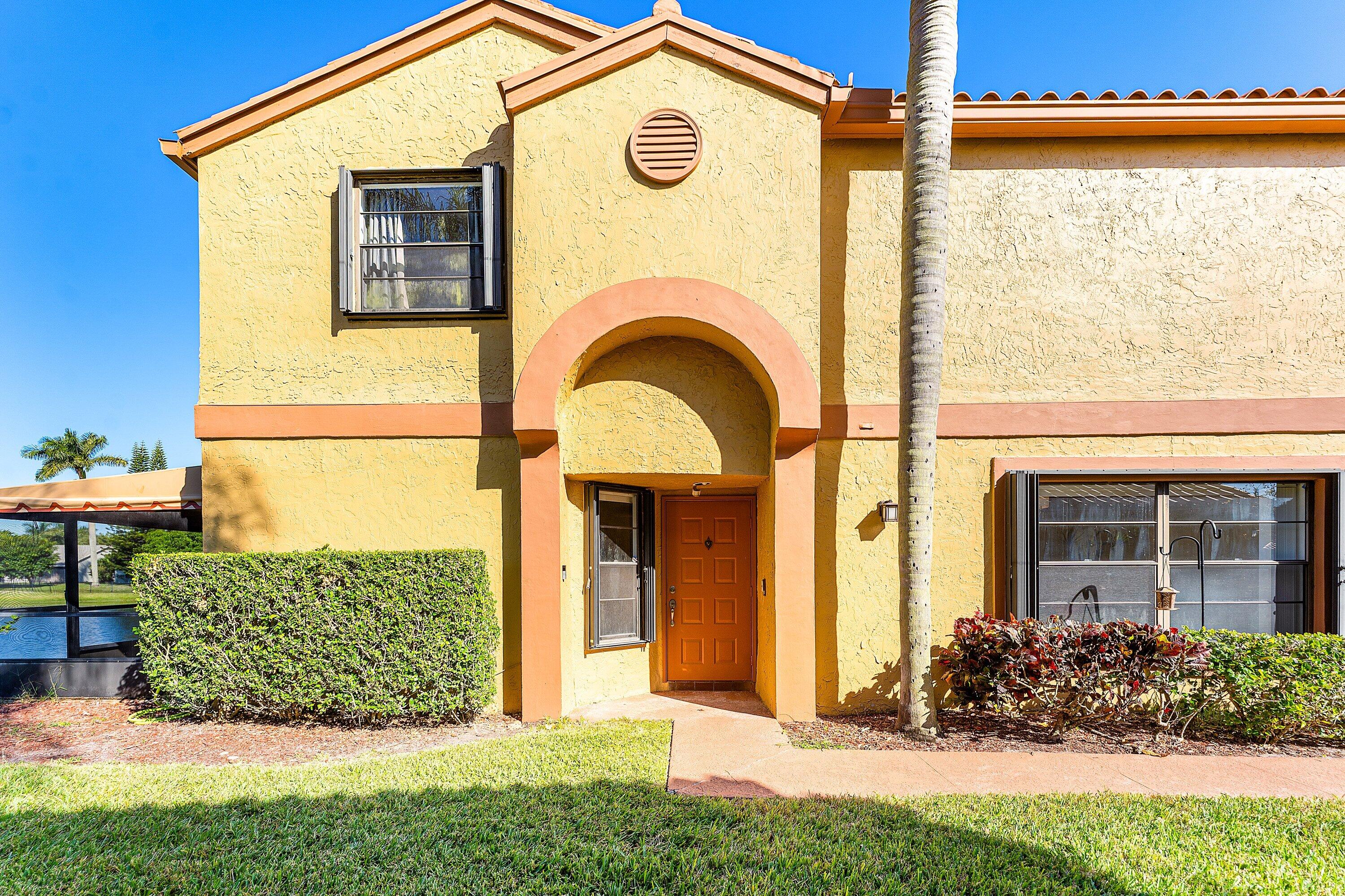 19931 Villa Lante Place Boca Raton, FL 33434 - Photo 4 of 49 a view of a brick house with a large windows and a yard
