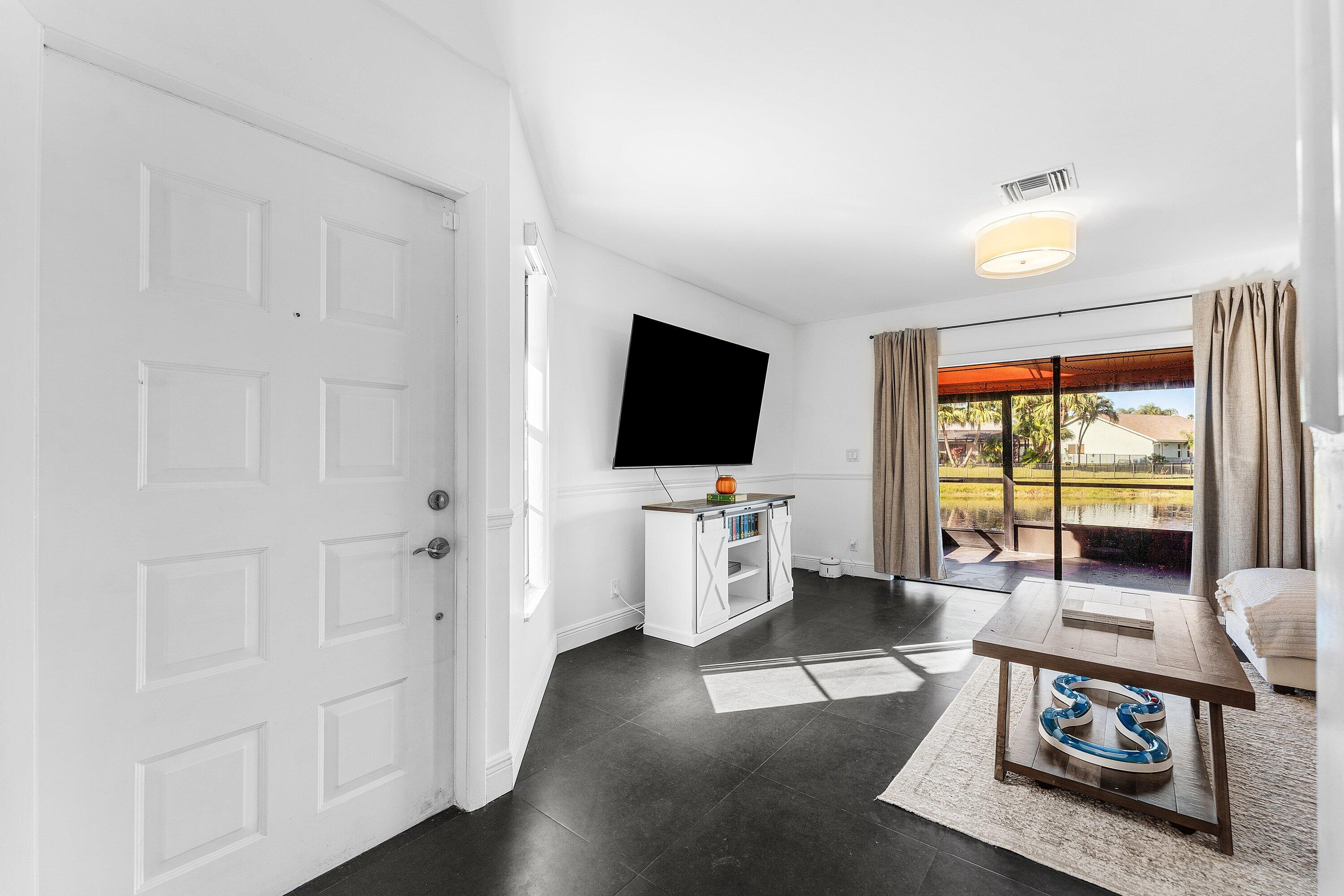 19931 Villa Lante Place Boca Raton, FL 33434 - Photo 5 of 49 a living room with furniture and a flat screen tv
