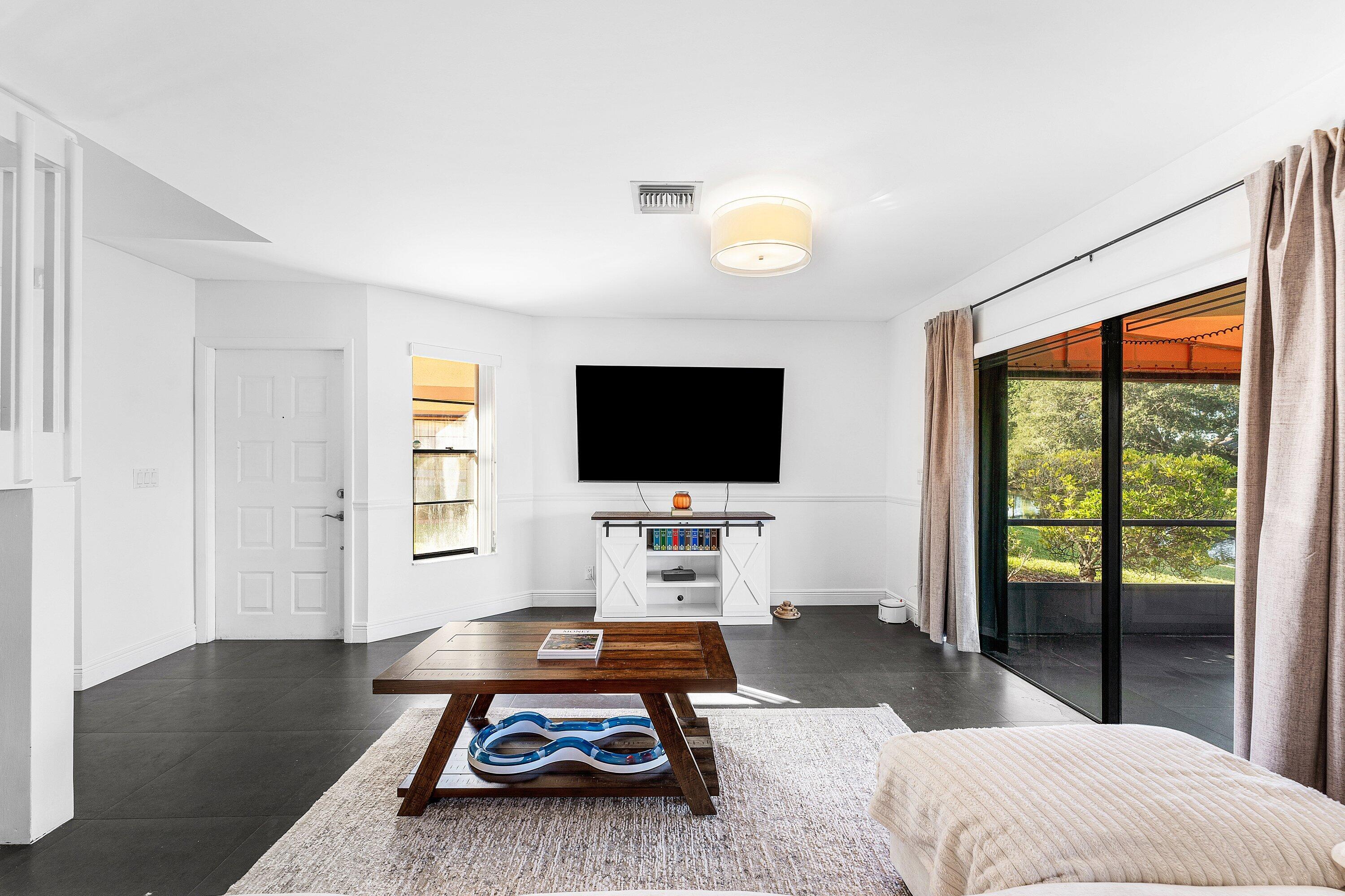 19931 Villa Lante Place Boca Raton, FL 33434 - Photo 7 of 49 a living room with furniture and a flat screen tv