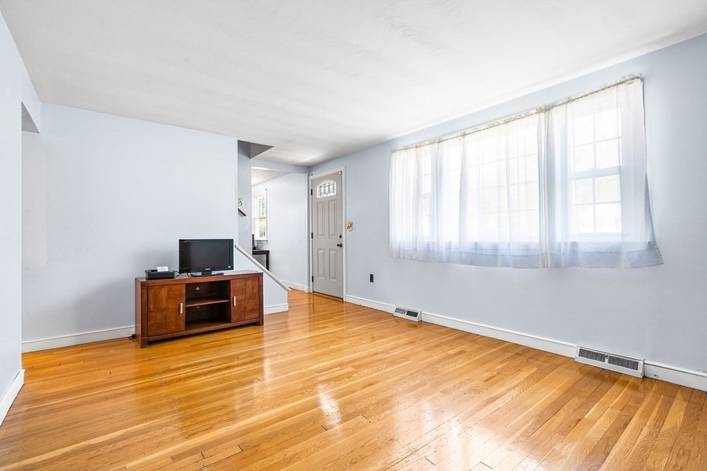 119 Spallus Road Stoughton, MA 02072 - Photo 8 of 38 a big room with wooden floor and furniture