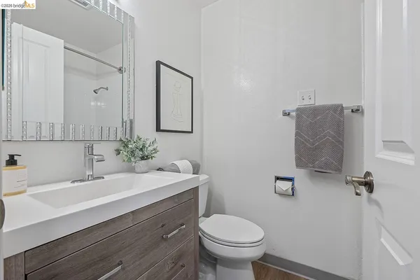 a bathroom with a sink toilet and mirror