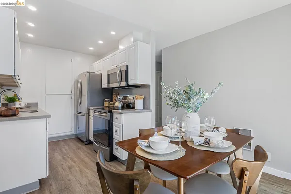 a kitchen with a dining table and chairs