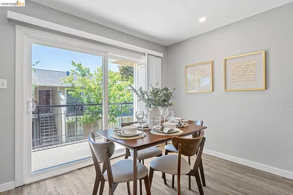 a view of a dining room with furniture window and wooden floor