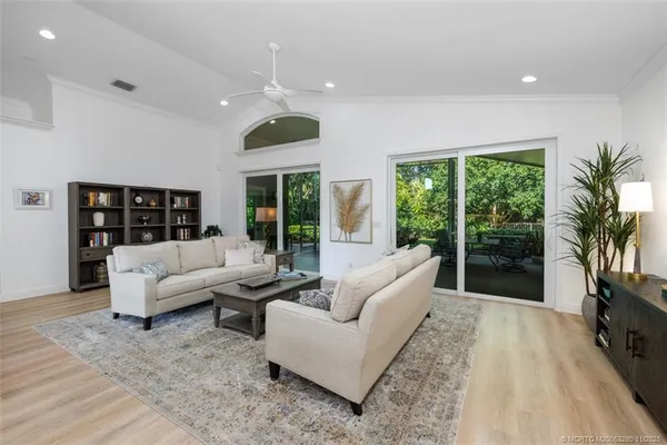 a living room with furniture large window and a flat screen tv