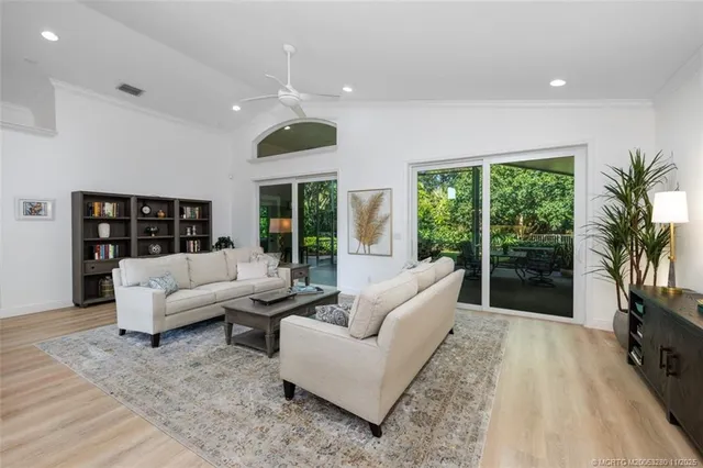 a living room with furniture large window and a flat screen tv