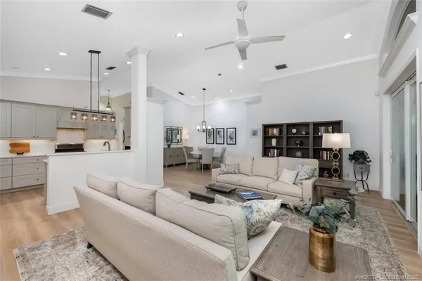 a living room with furniture and kitchen view