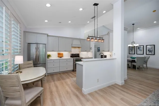 a kitchen with refrigerator cabinets and wooden floor