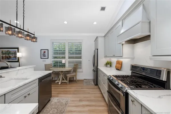 a kitchen with a stove a sink and a refrigerator