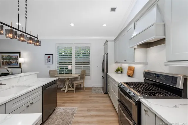 a kitchen with a stove a sink and a refrigerator