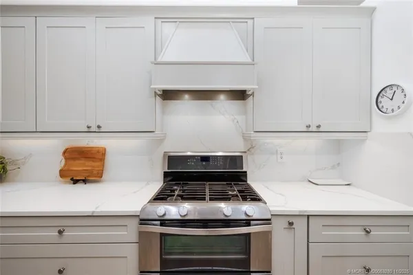 a stove top oven sitting inside of a kitchen