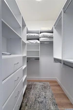 a view of walk in closet with empty racks