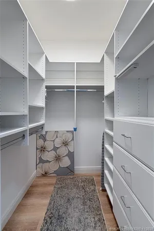 a view of walk in closet with empty racks