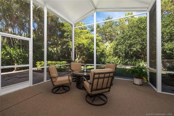 a living room with furniture and large windows